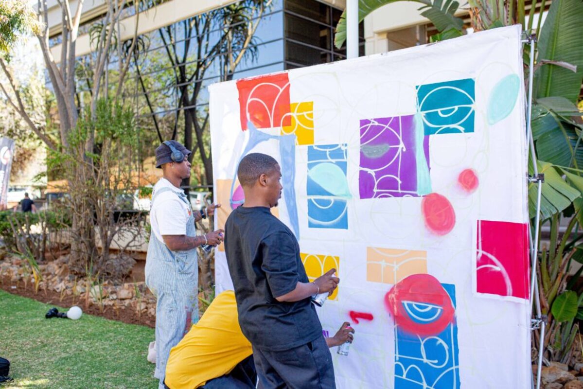 artistas fazendo grafites coloridos em uma tela branca